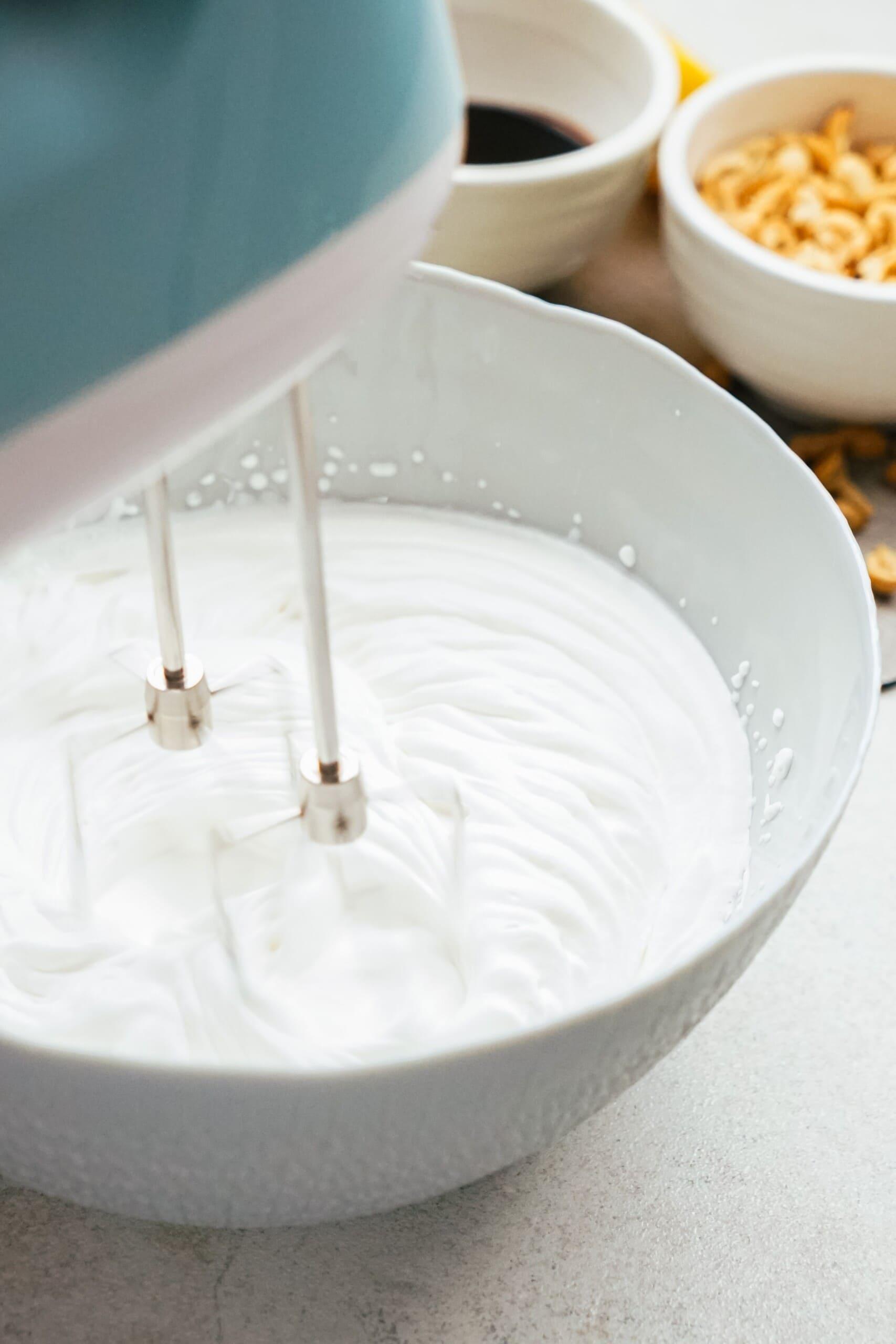 electric mixer beating heavy cream 