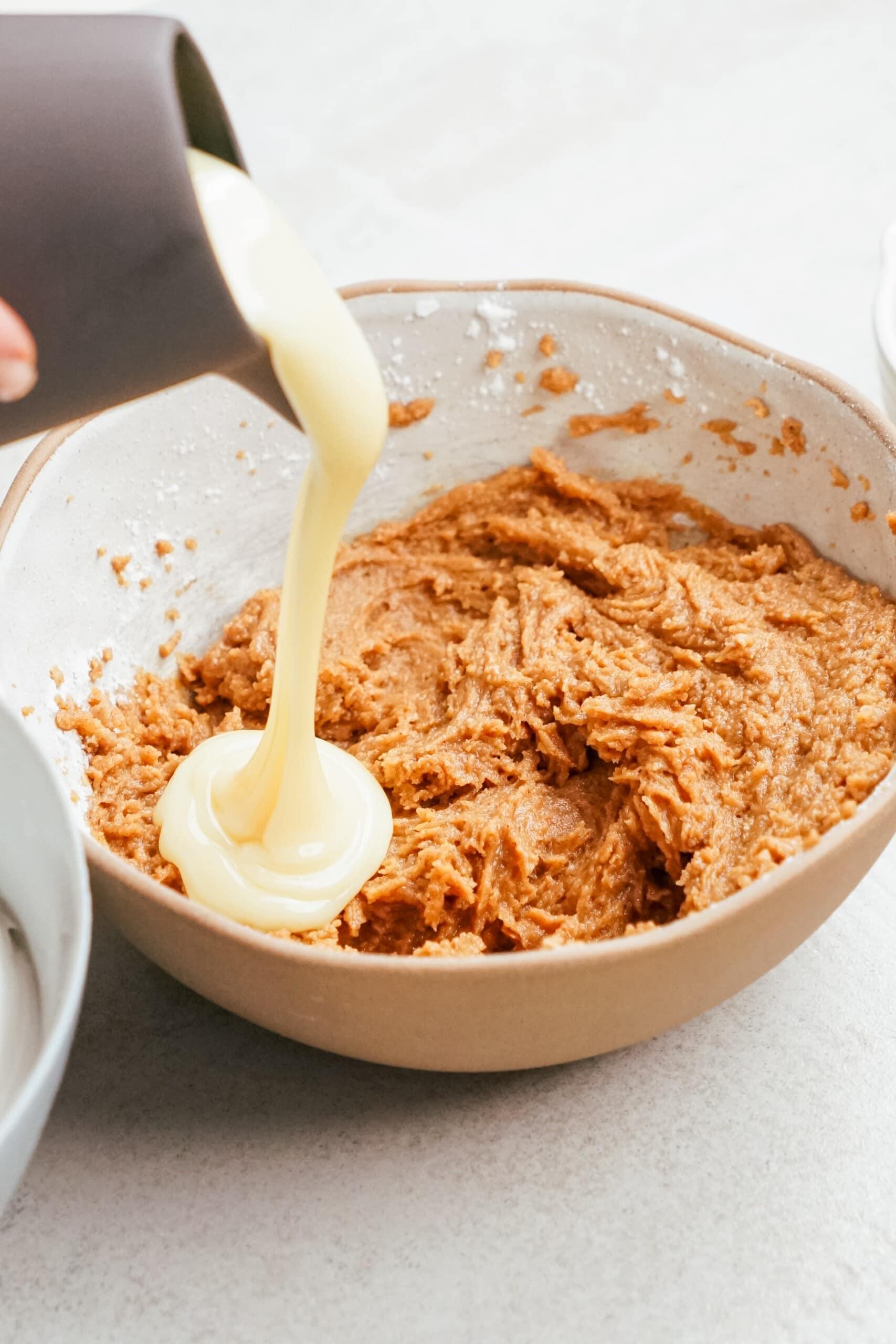 sweetened condensed milk being added to pb mixture