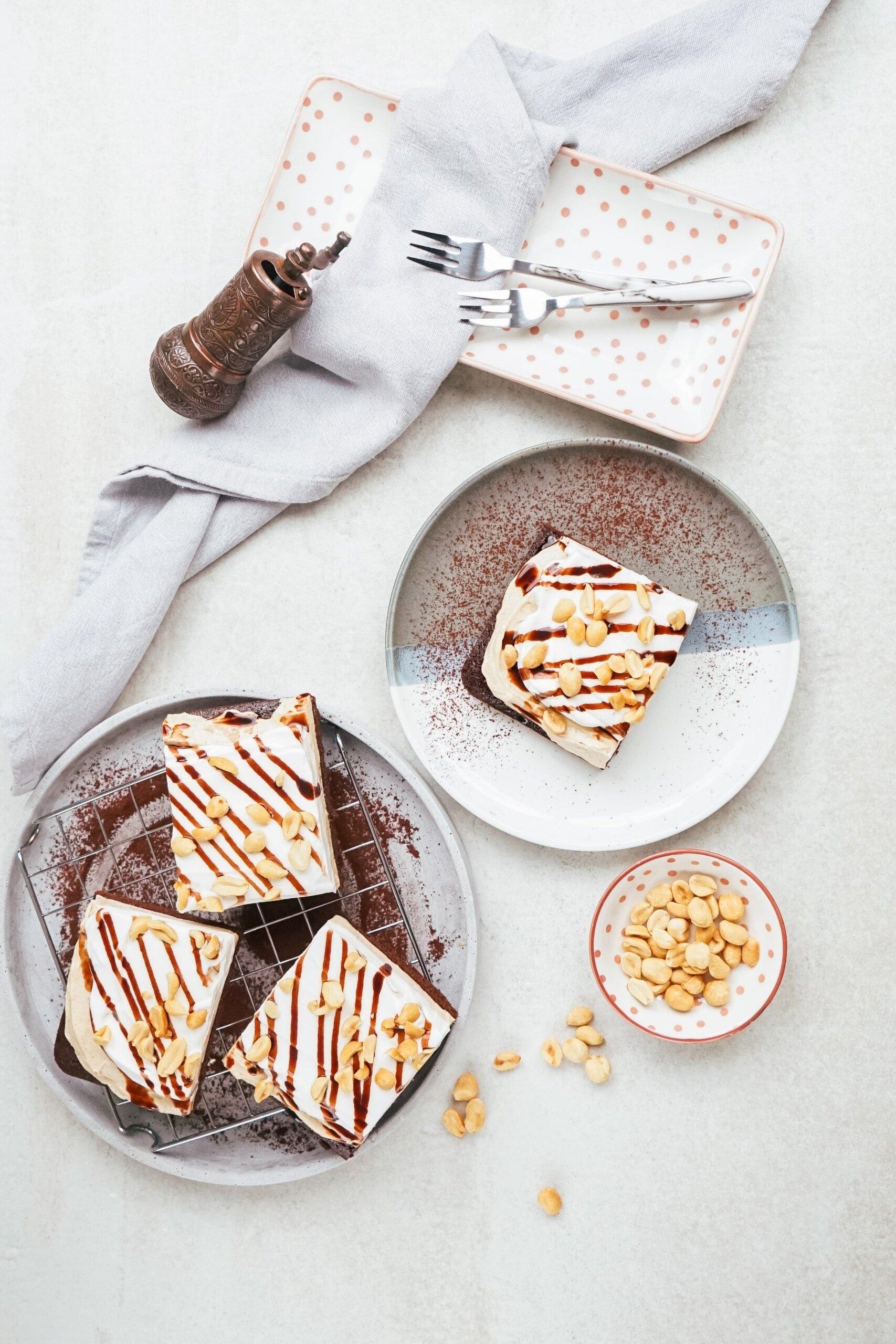 chocolate peanut butter pie sheet cake cut into bars on a tablescape