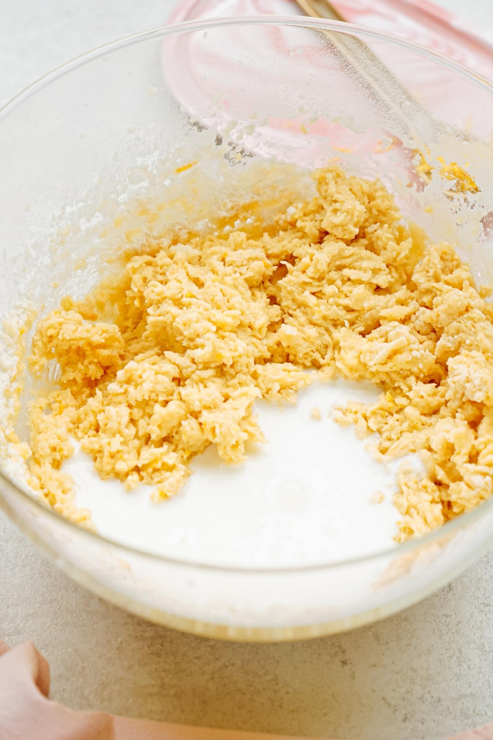 flour and leavening agents added to cake batter in a bowl