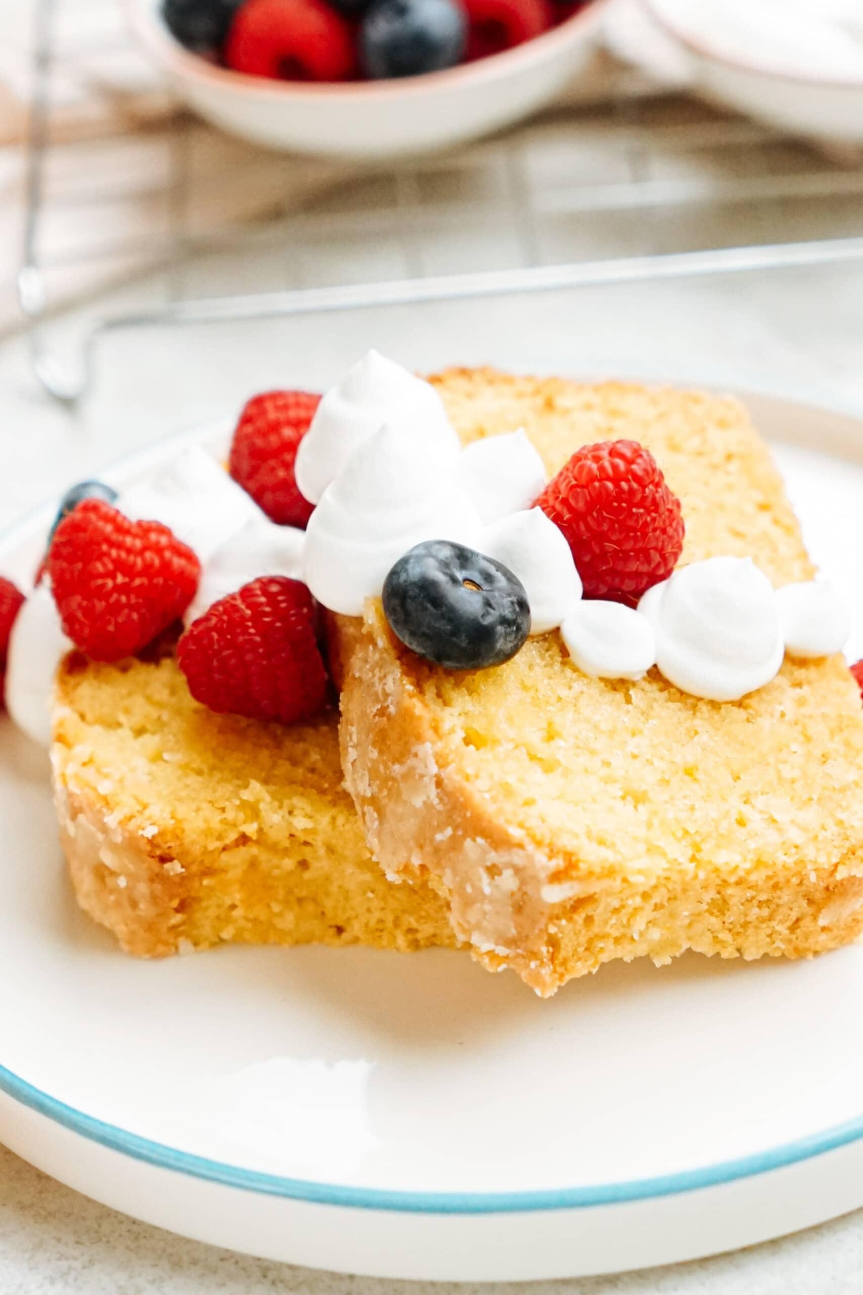 lemon poundcake with berries and cream on a plate