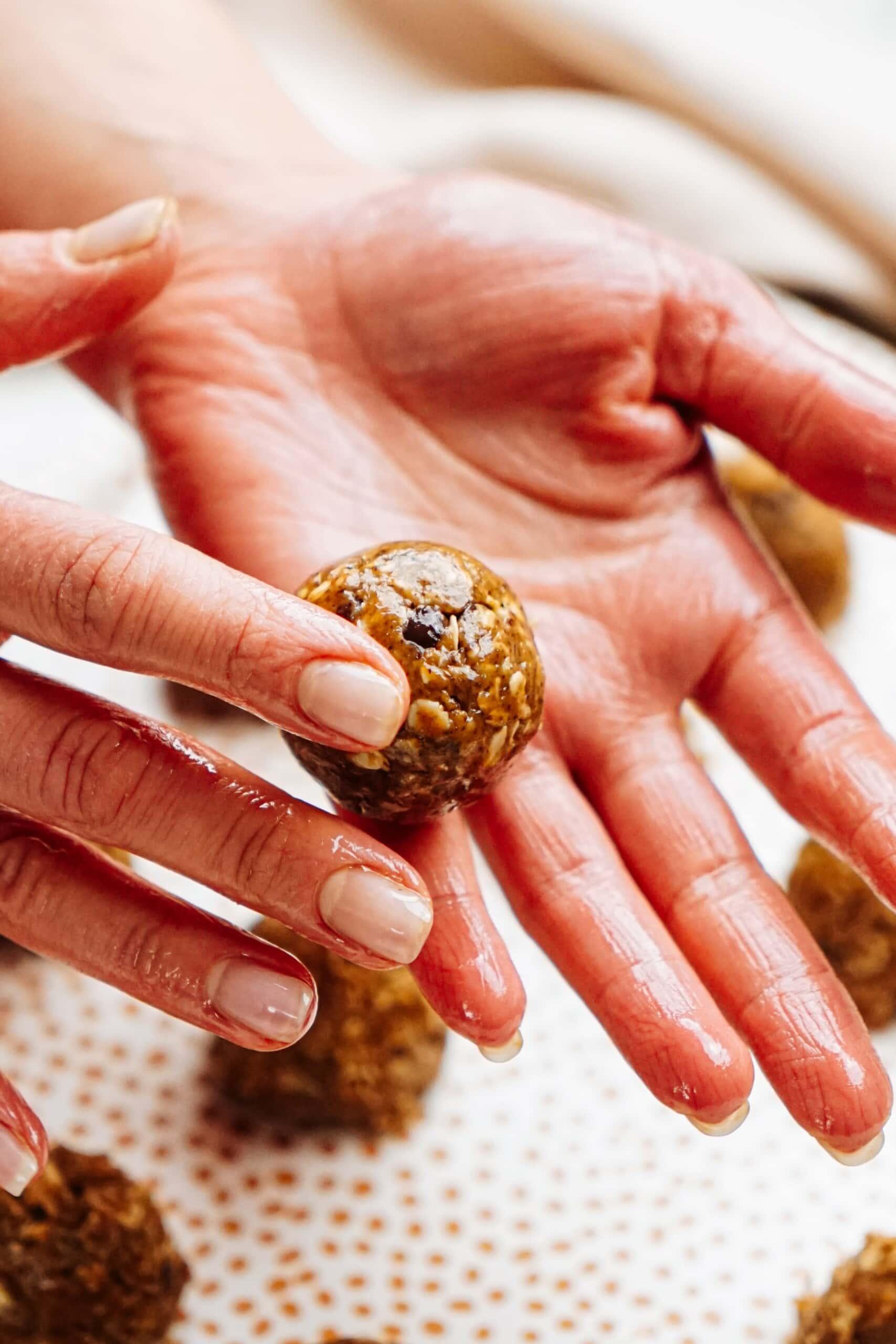 woman's hands rolling an energy ball in her hands