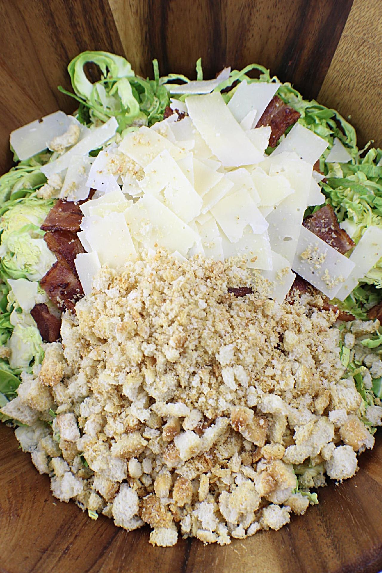 Brussels Sprouts Caesar Salad ingredients in wooden salad bowl