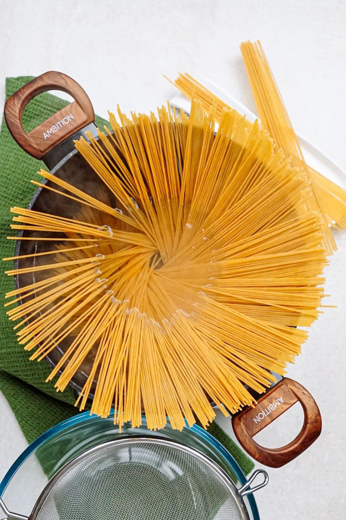 spaghetti noodles in a large pot of water