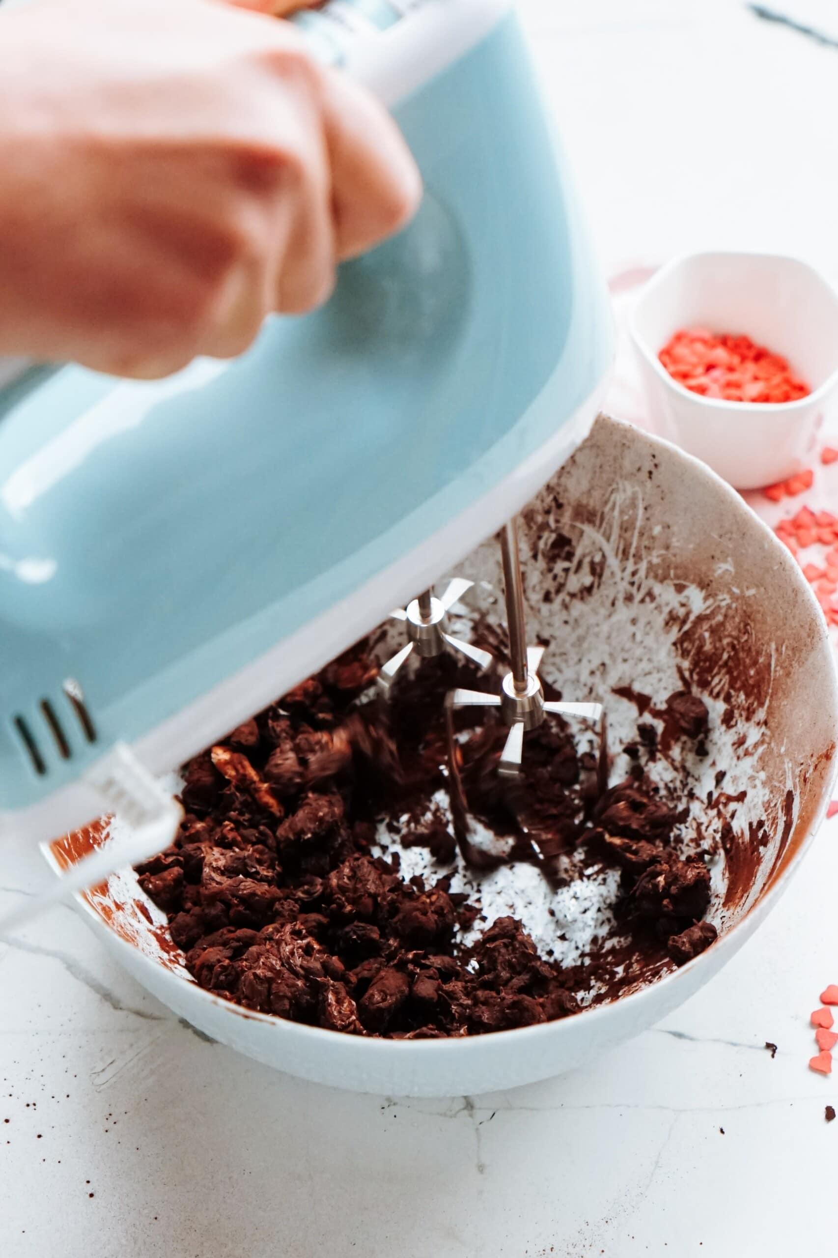 hand held mixer combining cake and frosting