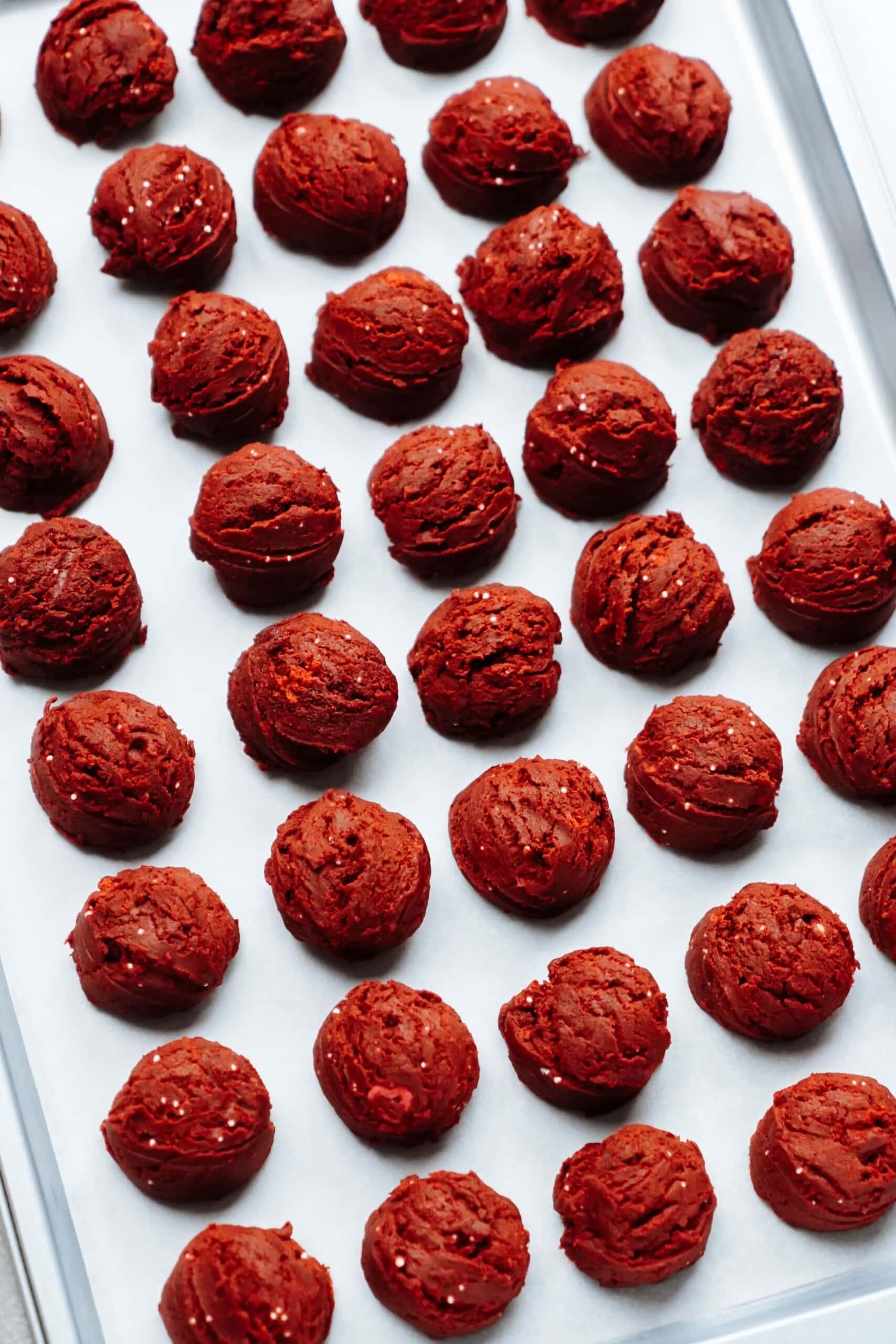 cake pops lined up on a baking sheet 