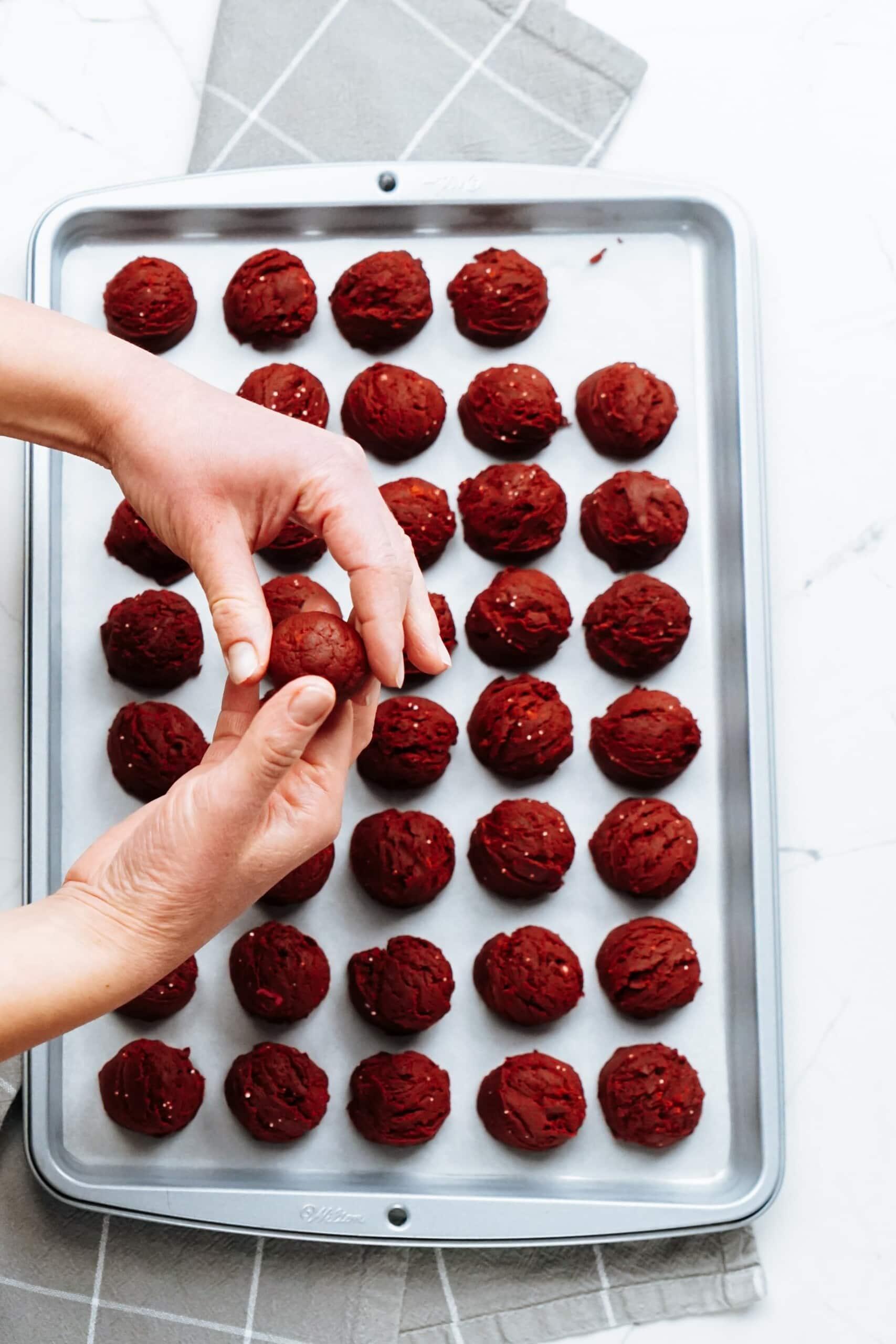 womans hands rolling each cake ball in the palms of her hands