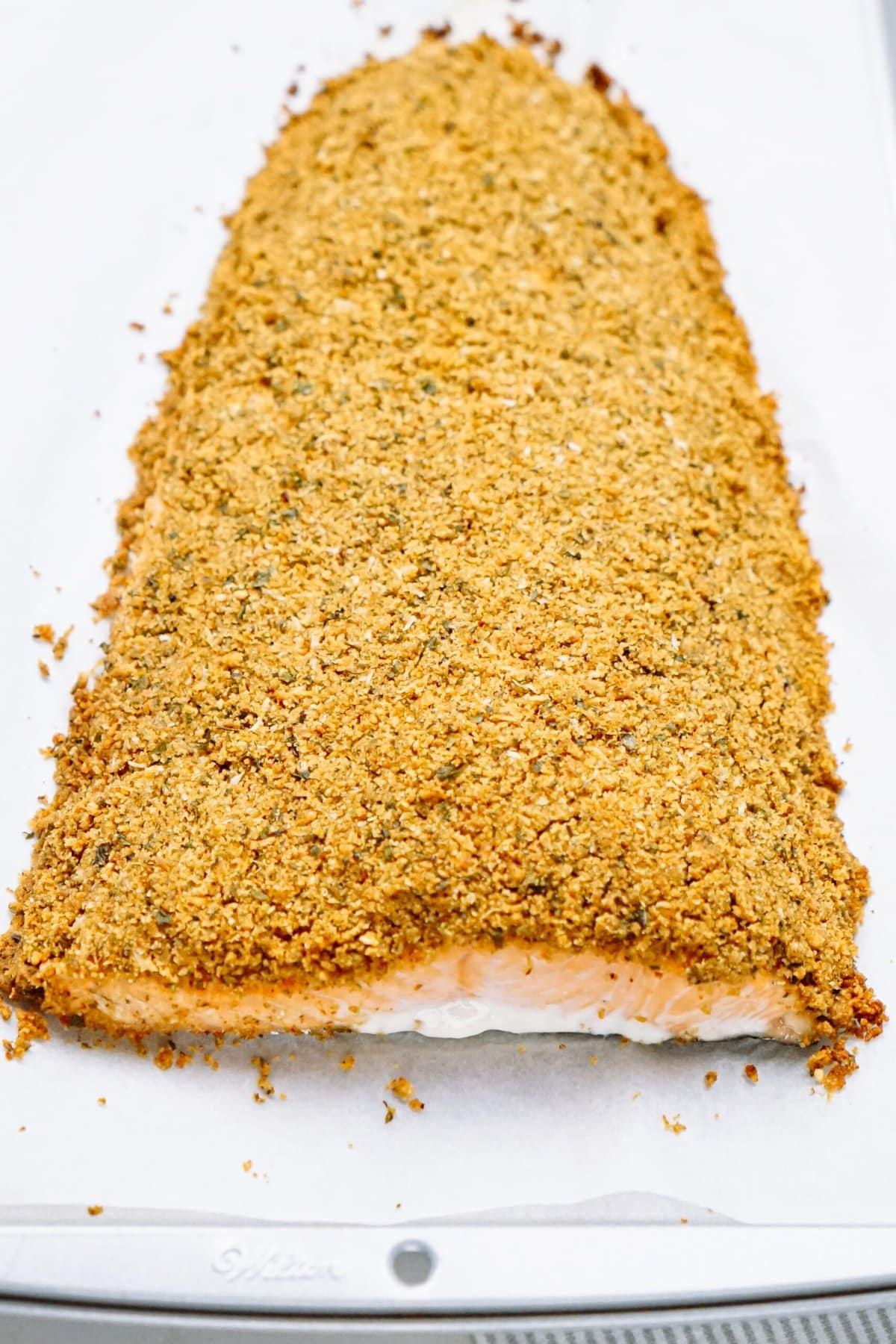 breaded salmon on a baking sheet