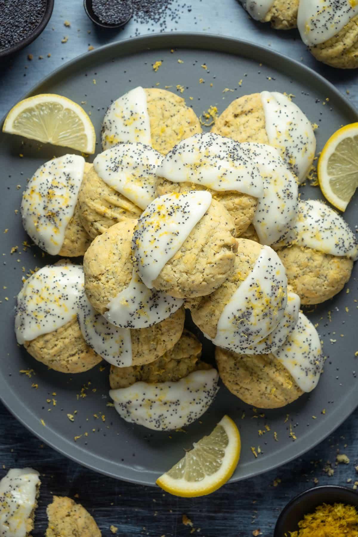 Vegan Lemon Poppy Seed cookies stacked on a grey plate.