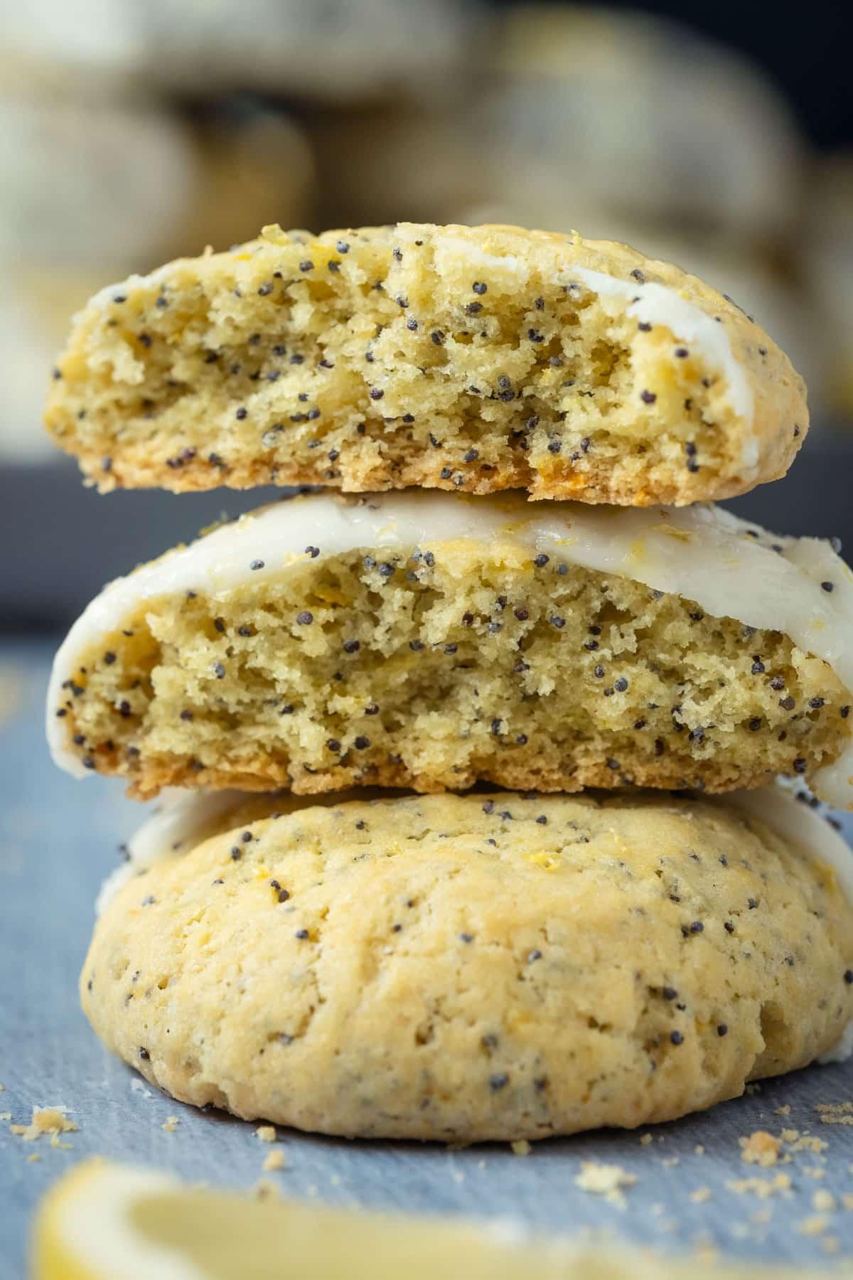 Vegan lemon poppy seed cookies broken up and stacked on top of each other.