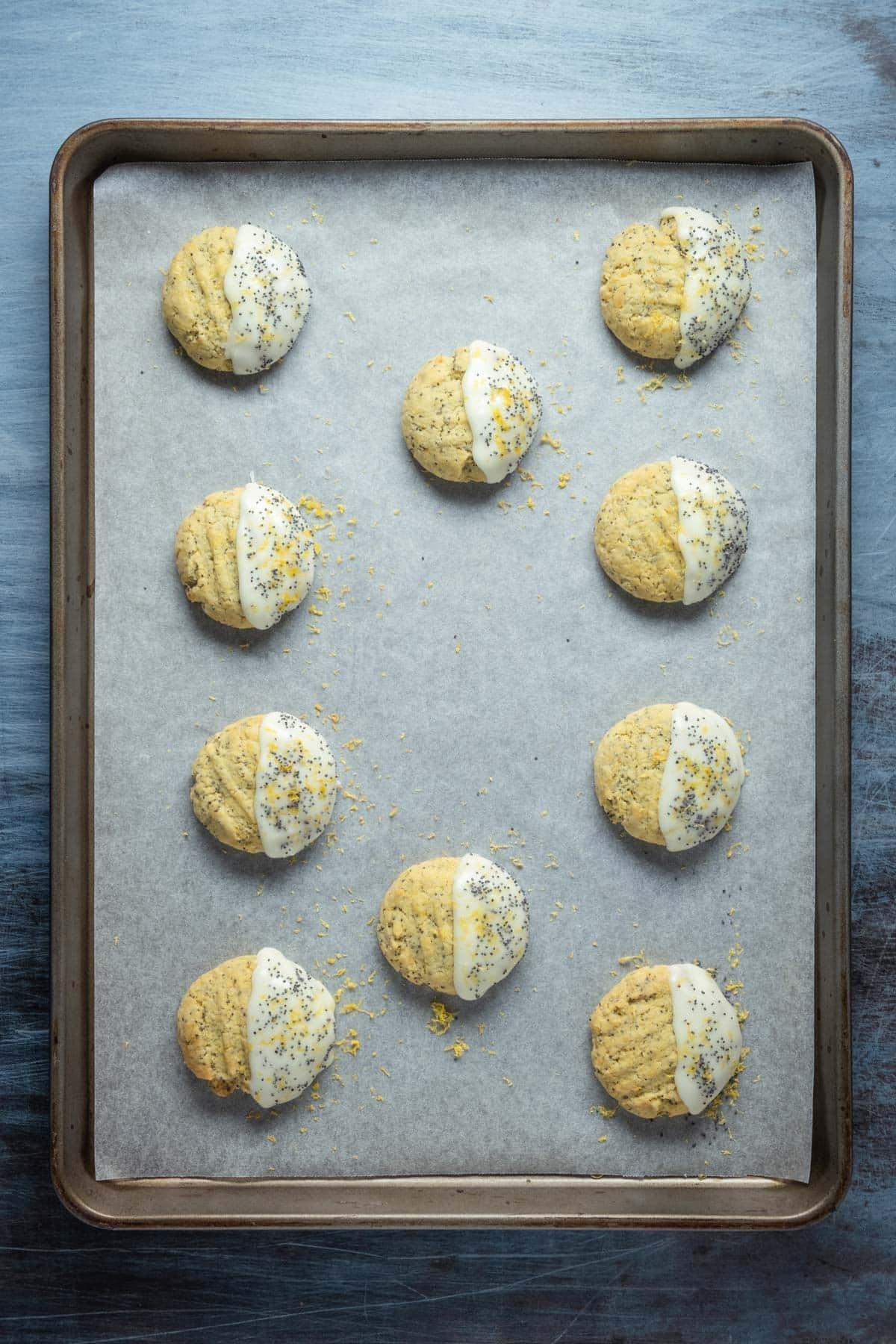 Spread the glaze on half of the cookies and top with lemon zest and poppy seeds.