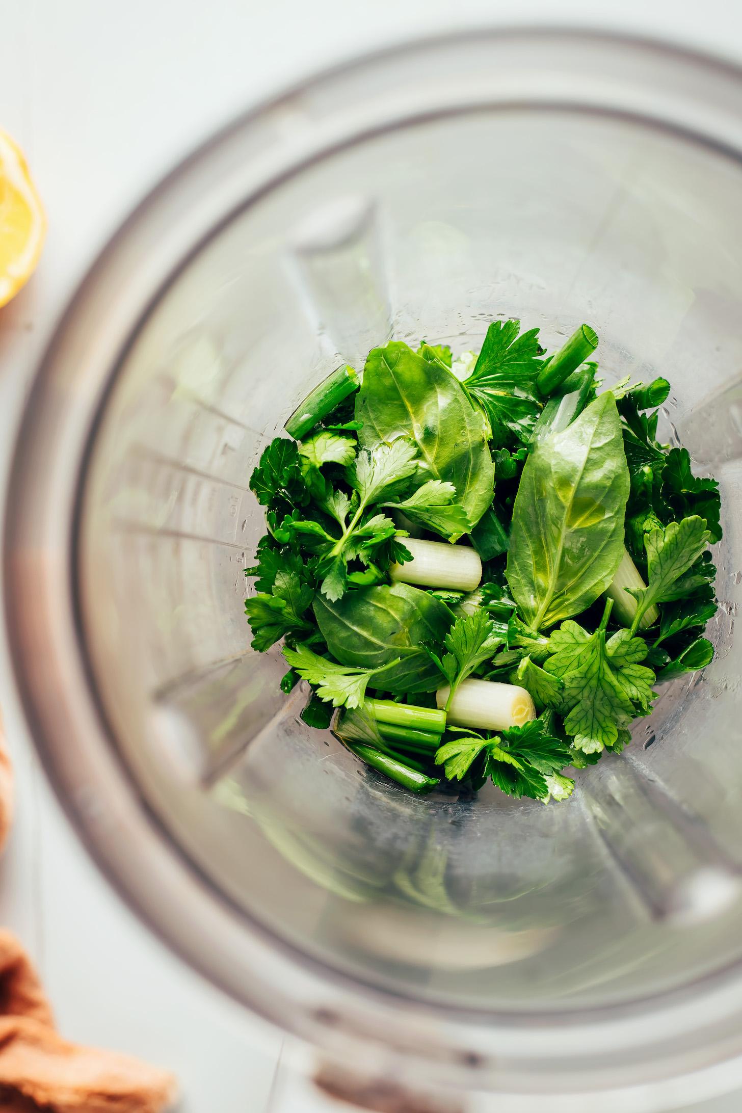 Fresh herbs and green onions in a blender