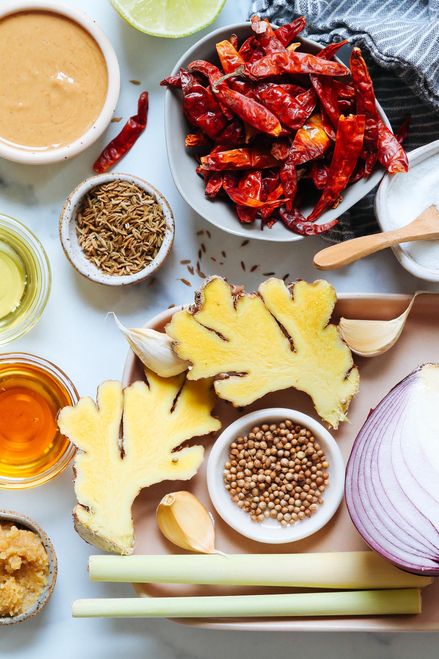 Dried Thai chili peppers, lime, peanut butter, cumin seeds, oil, maple syrup, miso paste, lemongrass, garlic, coriander seeds, ginger, red onion, garlic, and salt