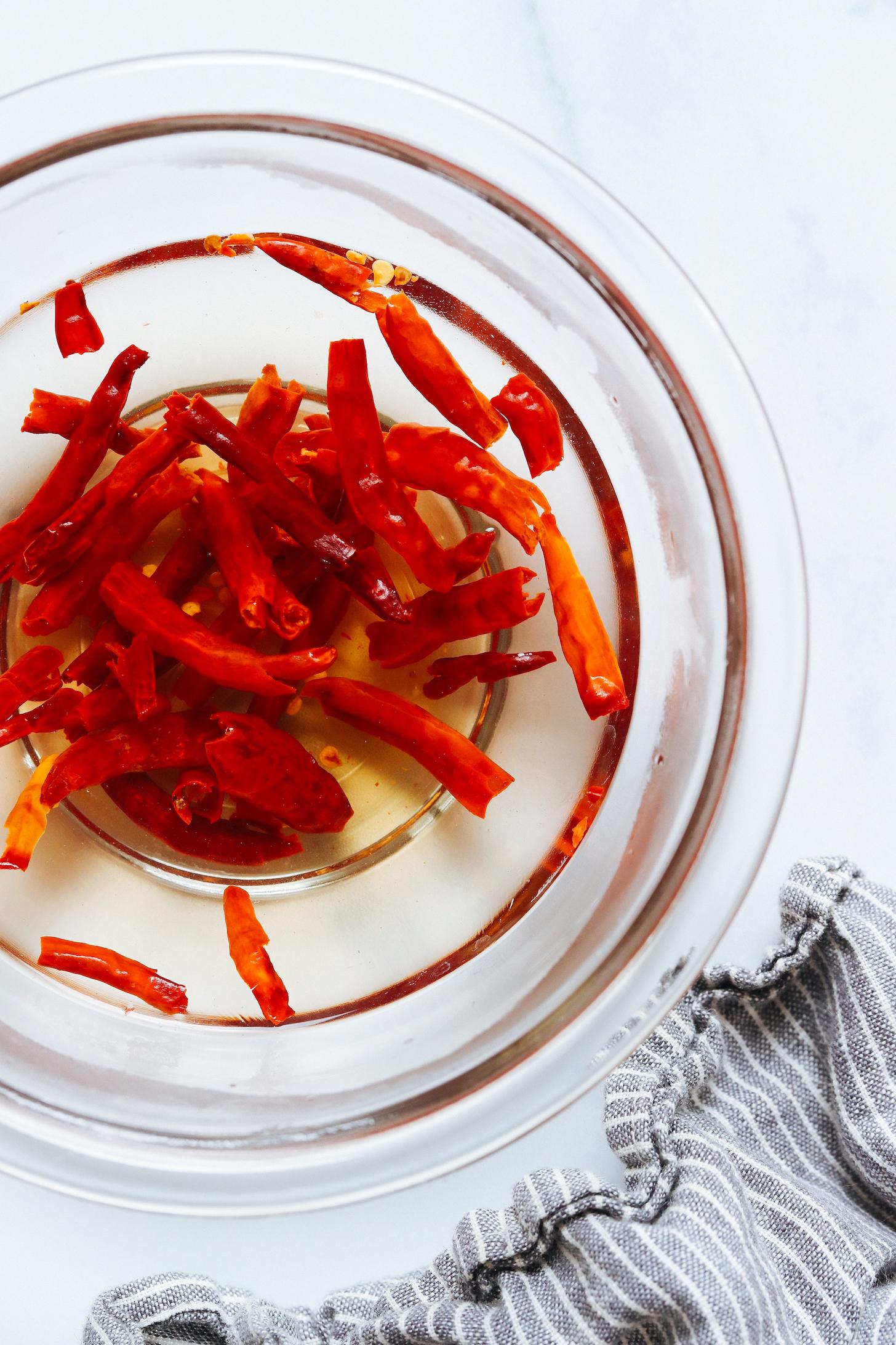 Soaking dried Thai chili peppers in hot water