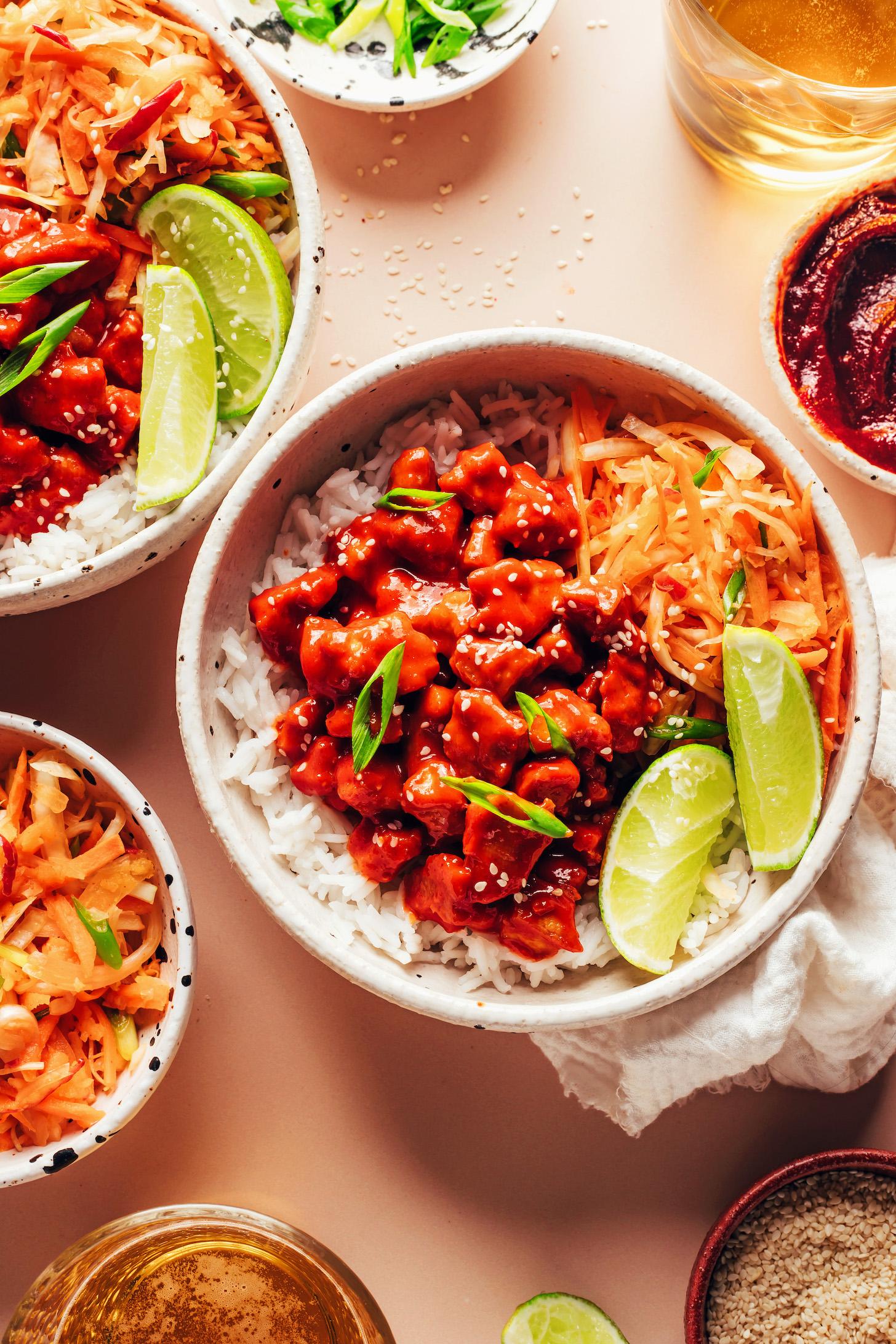 Korean-inspired bowl with gochujang tofu, cabbage apple slaw, rice, and lime wedges