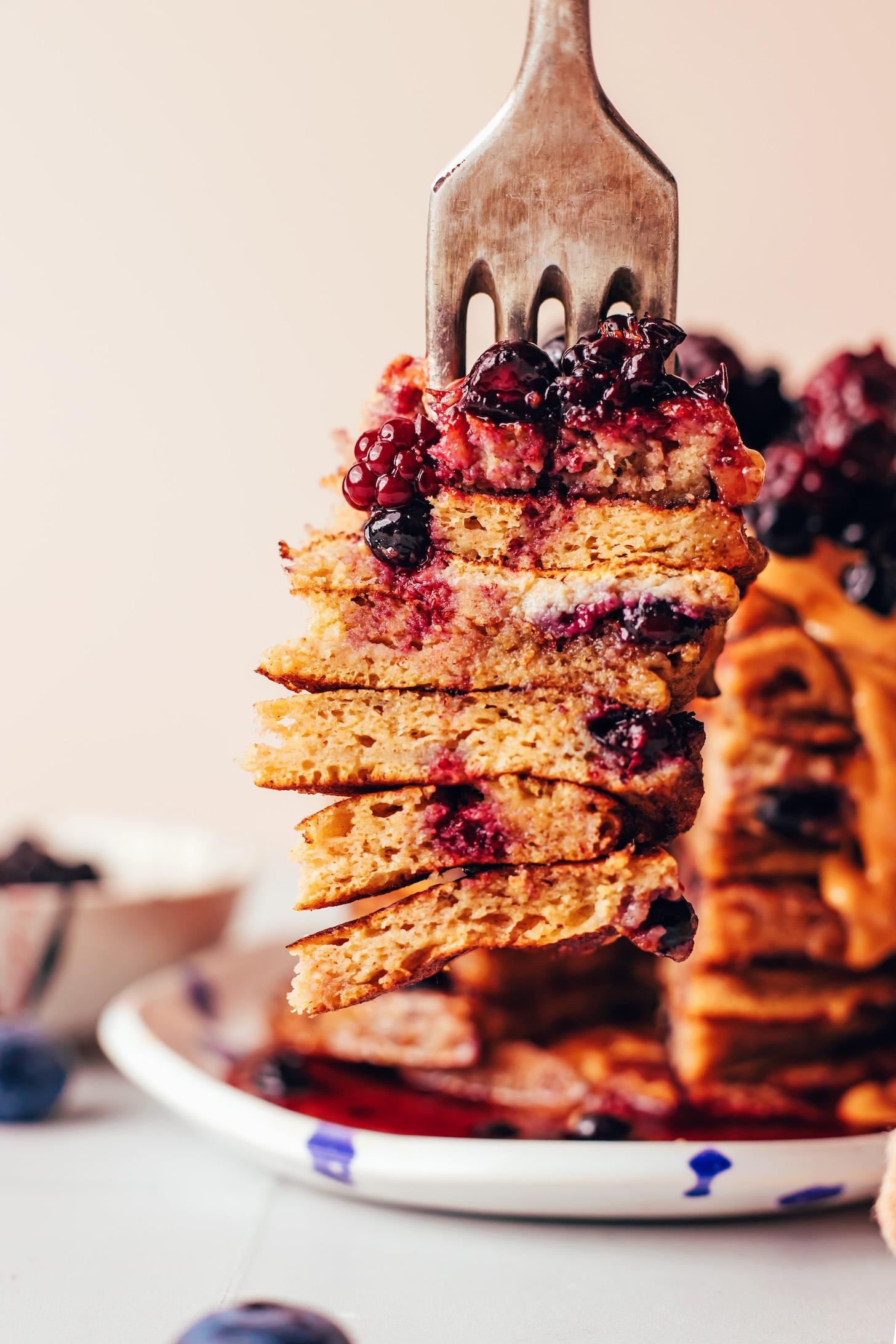 Fork spearing a big slice of a stack of pancakes