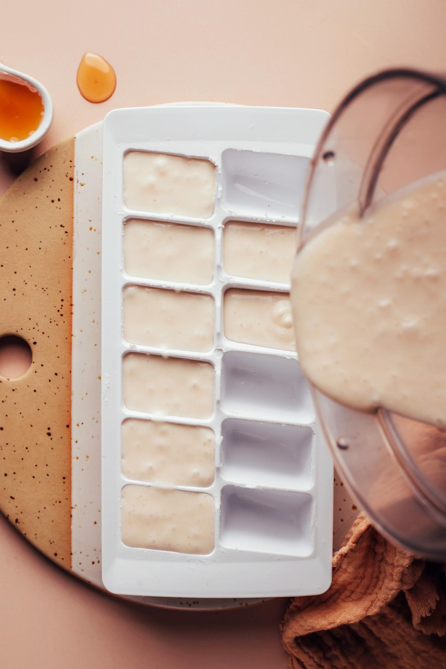 Pouring a sweet vanilla coconut mixture into an ice cube tray