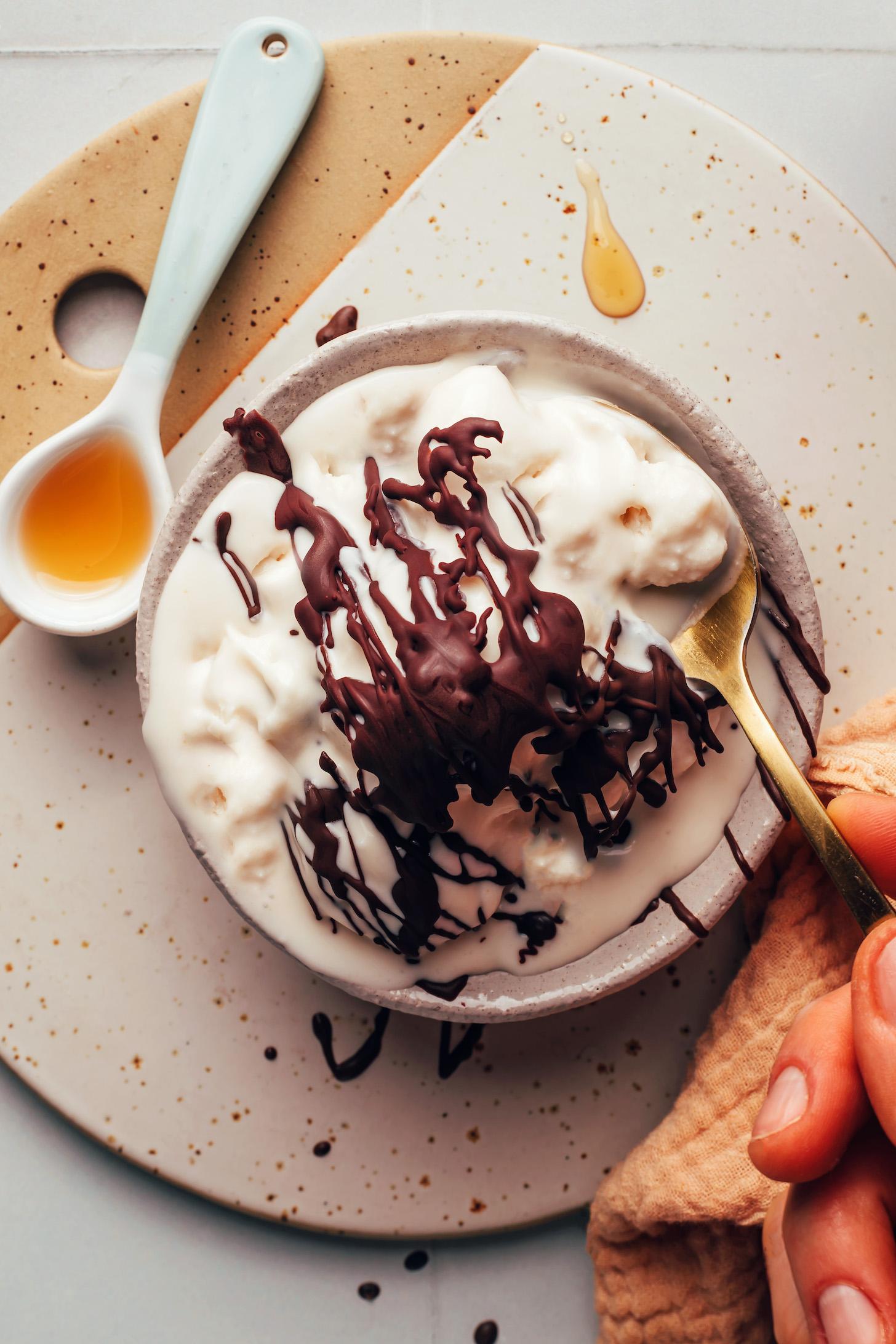 Bowl of vegan vanilla soft serve topped with chocolate magic shell