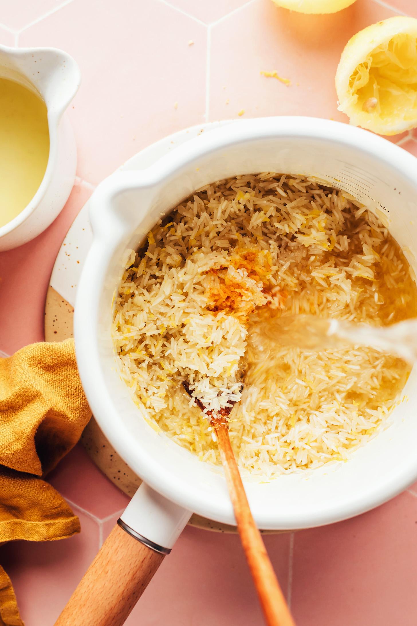 Pouring water into a saucepan of rice