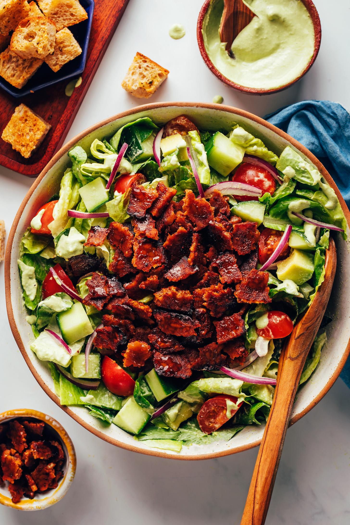 Crumbled tempeh bacon on top of a salad