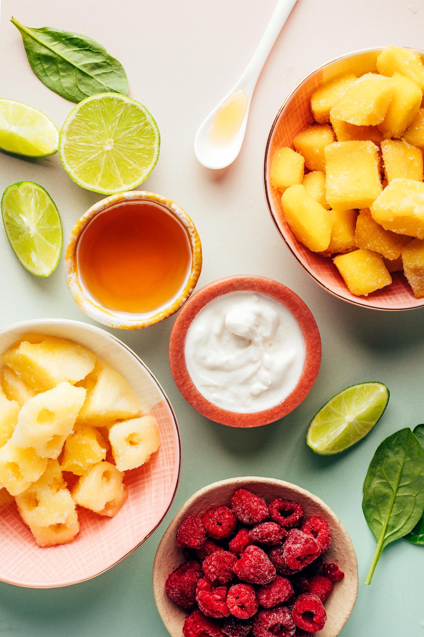 Frozen mango, raspberries, and pineapple, plus lime, spinach, coconut milk, and maple syrup