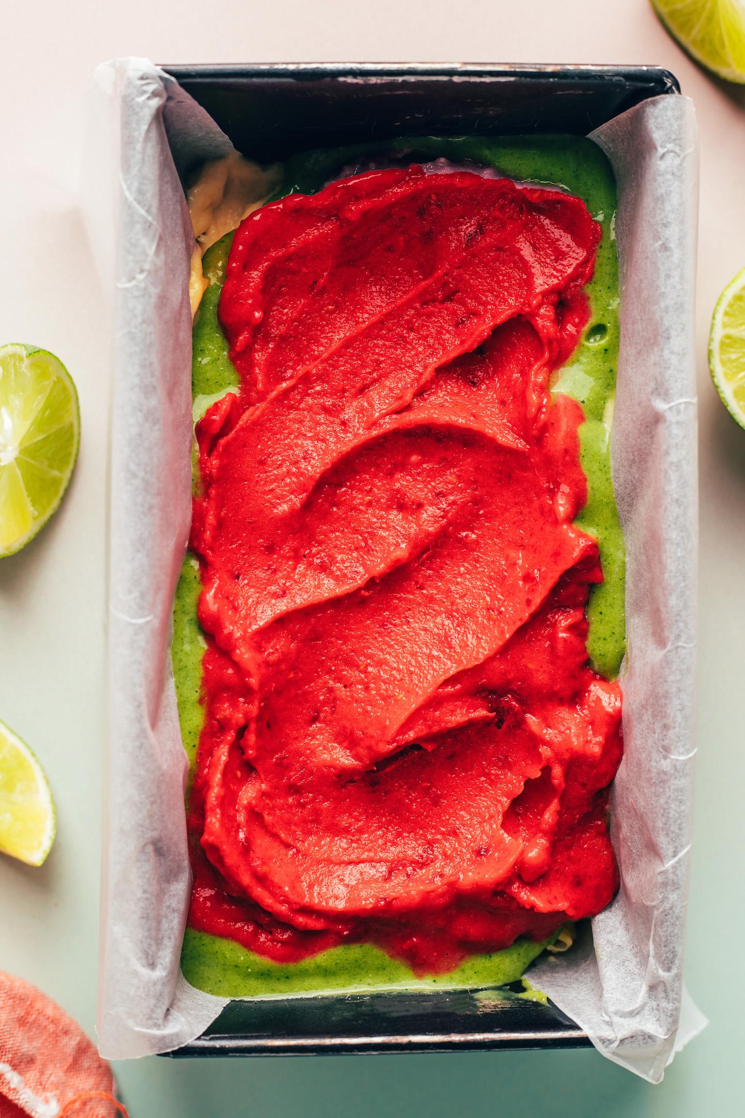 Loaf pan with layers of yellow, green, and pink ice cream