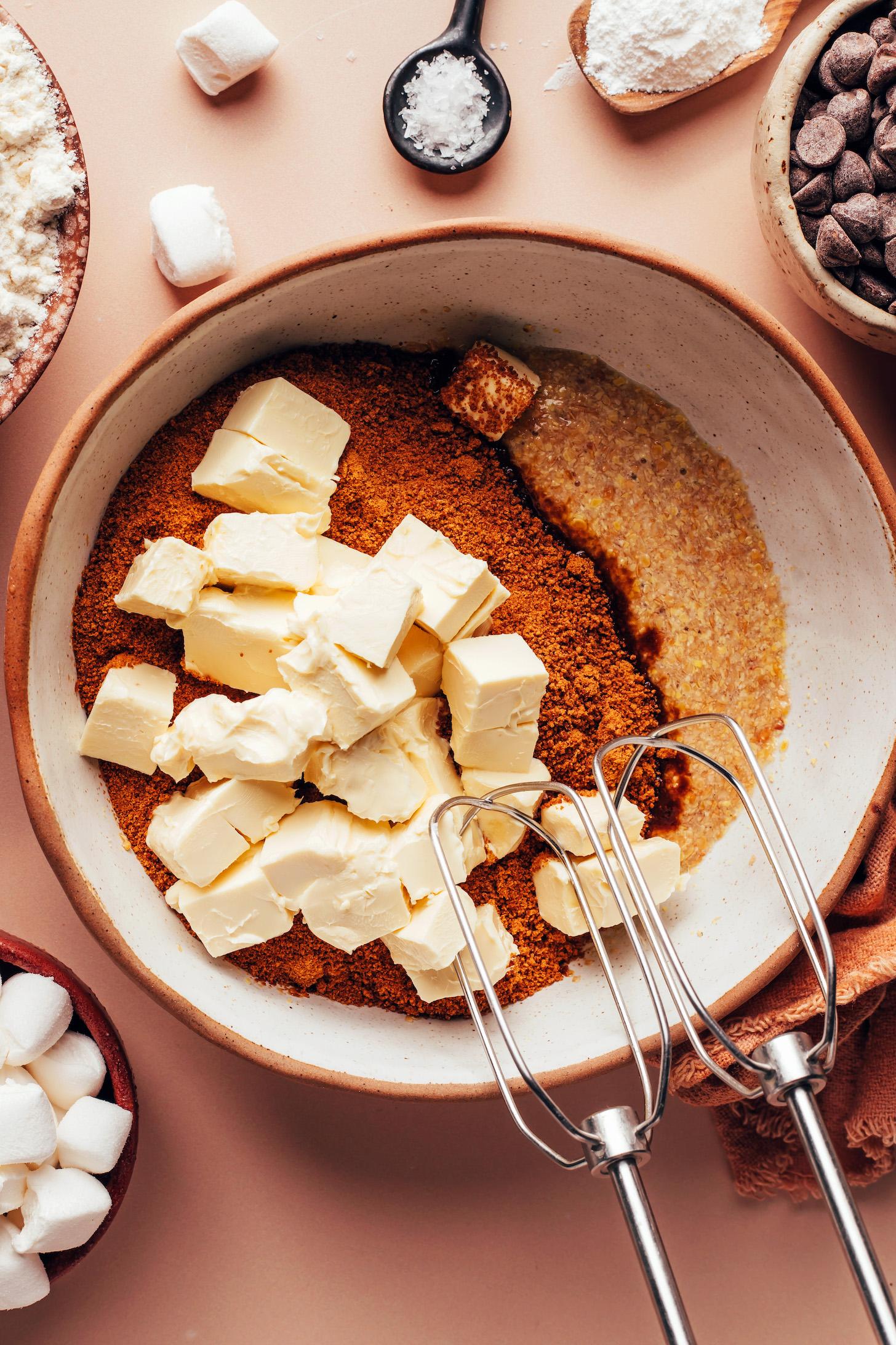 Cubed vegan butter in a bowl with coconut sugar and a flax egg