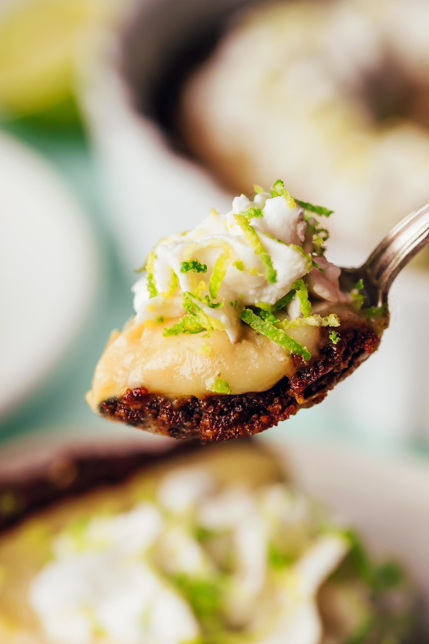 Close up shot of a bite of vegan key lime pie on a fork