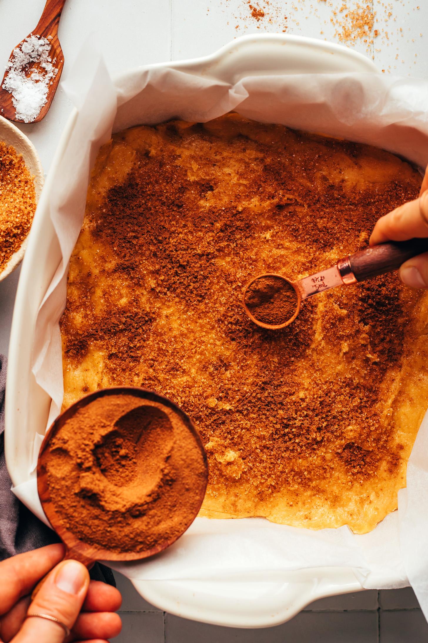 Sprinkling a brown sugar and pumpkin pie spice mixture over pumpkin cake batter