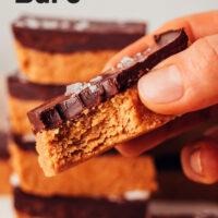 Close up photo of a peanut butter cup bar with text above it that says no-bake and 1 bowl