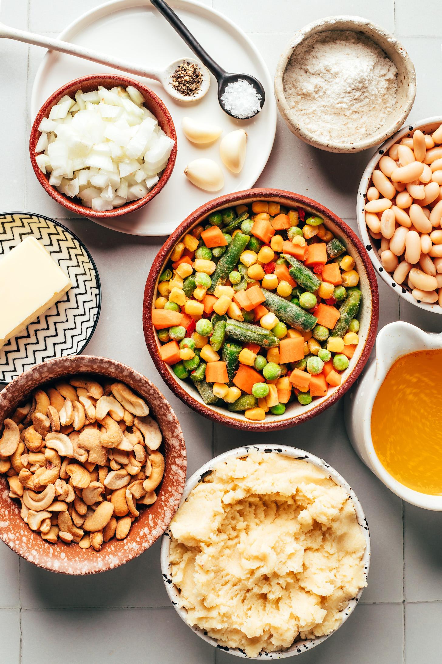 Gluten-free biscuit dough, cashews, vegan butter, mixed frozen vegetables, onion, garlic, salt, pepper, gluten-free flour blend, white beans, and vegetable broth