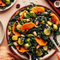 Using serving utensils to mix our Roasted Fall Vegetable Salad recipe