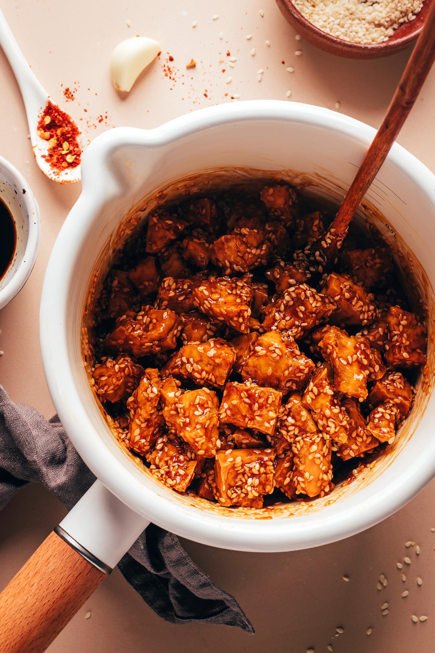 Pieces of crispy baked tofu coated in a sticky sesame glaze