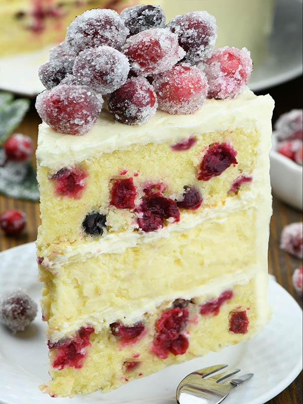 White chocolate cranberry cheesecake with sparkling cranberries, on a plate