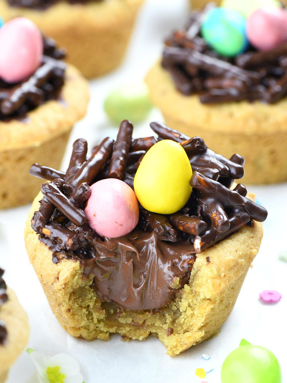 Bitten Cookie cup, filled with Nutella and Chocolate-Pretzel Nest with 2 easter eggs (candies) on the top.