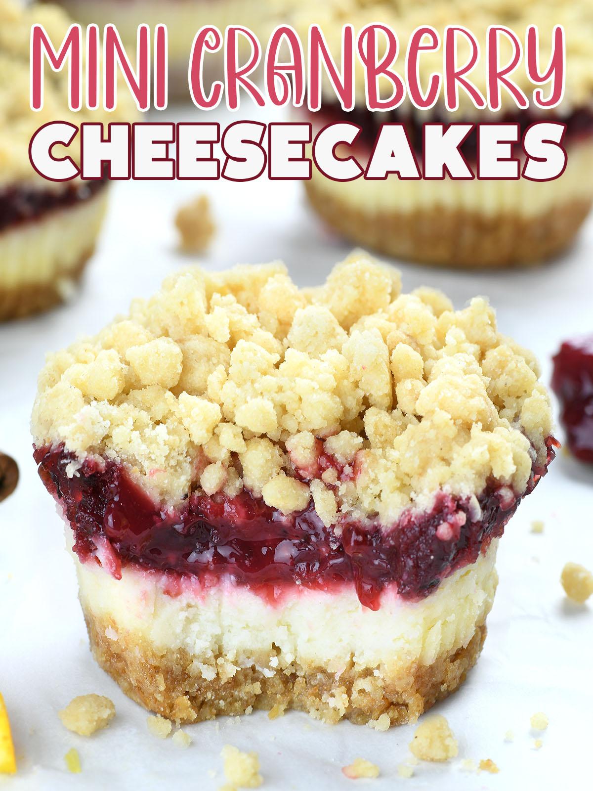 A slice of mini cranberry cheesecake on white baking paper with streusel topping.