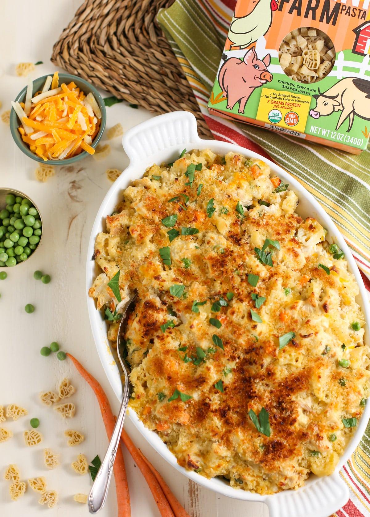 Baked Chicken noodle casserole in white ceramic baking dish.