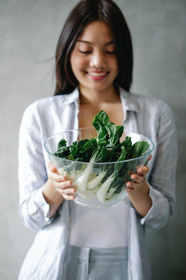 VegNews.womanholdingbokchoyinabowl.pexels
