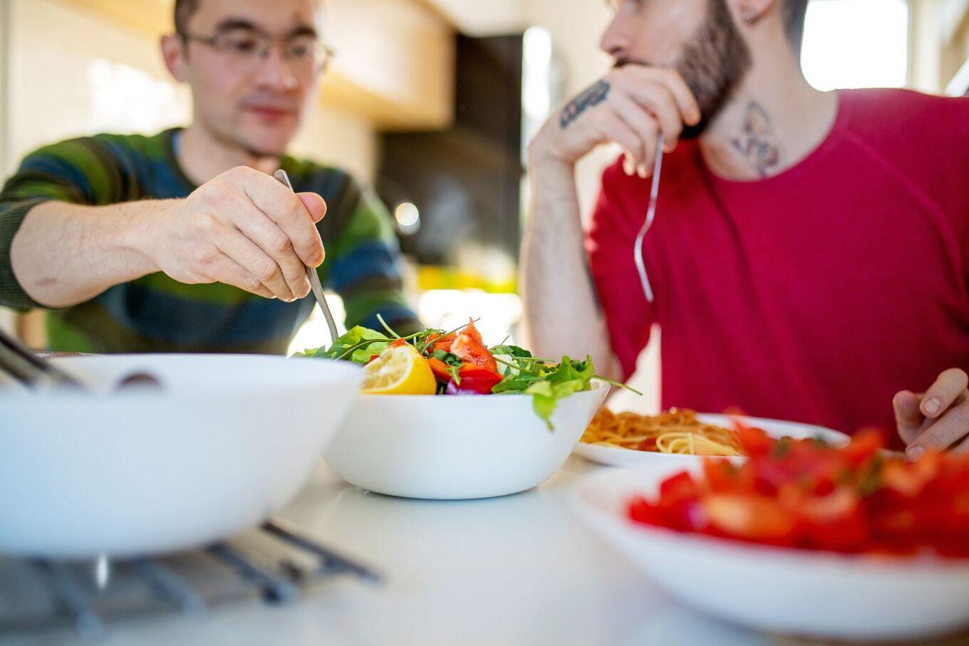 VegNews.MenEatingSalad.Getty