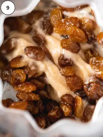 Closeup shot of the ice cream churning after adding the rum-soaked raisins to the machine.