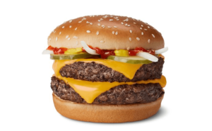 A burger with cheese and pickles on a white background.