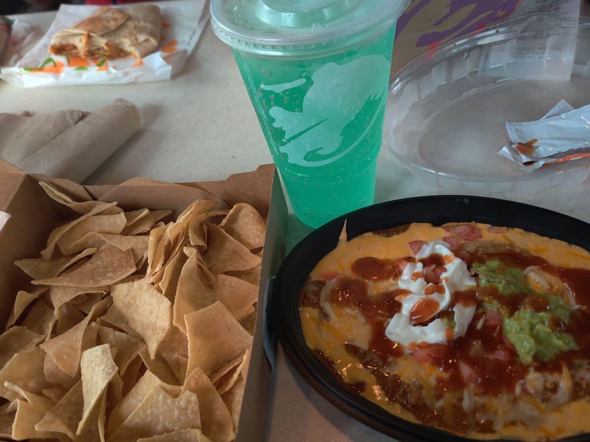 A bowl of guacamole and chips.