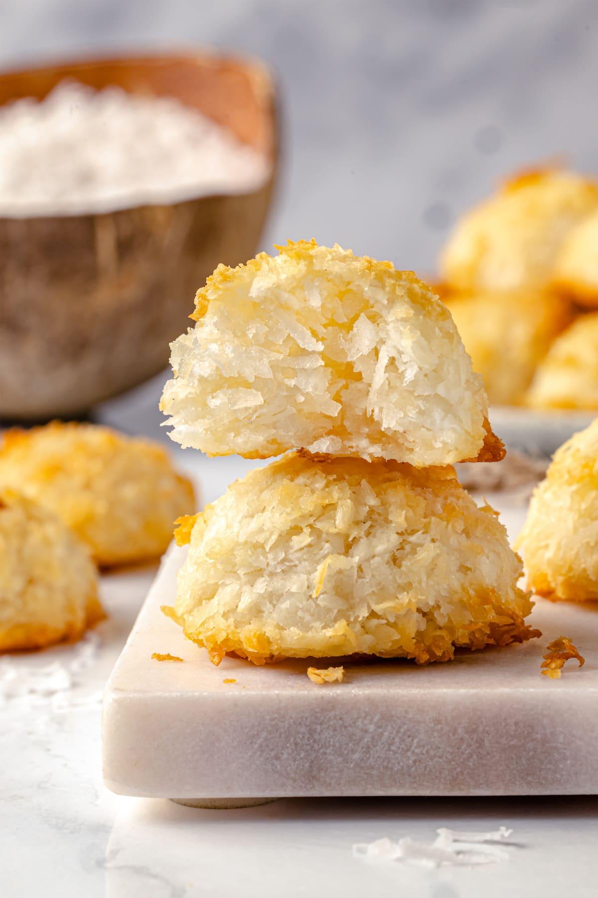 Two coconut macaroons stacked on each other, one showing the inside.