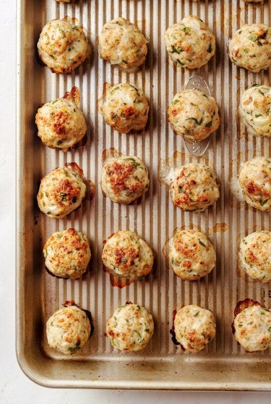 Cooked mini turkey meatballs on a baking sheet