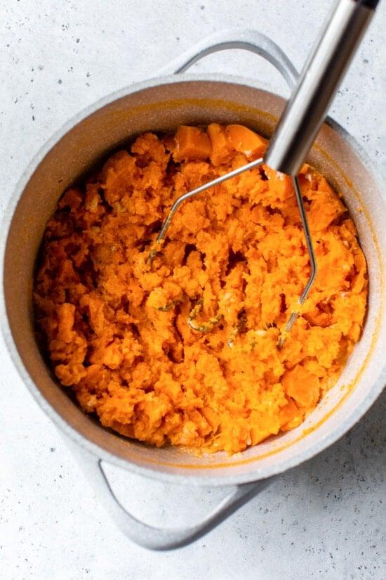 mashing sweet potatoes