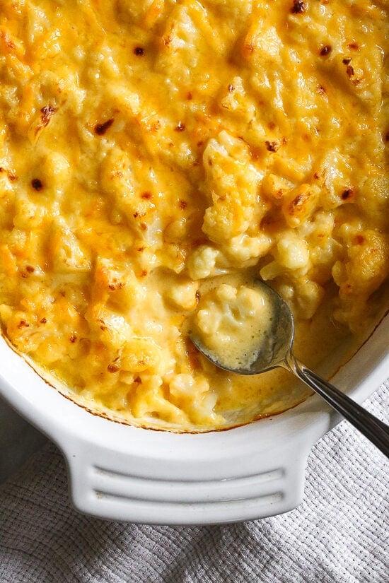 This cheesy Baked Cauliflower "Mac" and Cheese is perfect when you're craving mac and cheese without the pasta! It's lower in carbs and filled with protein and veggies!