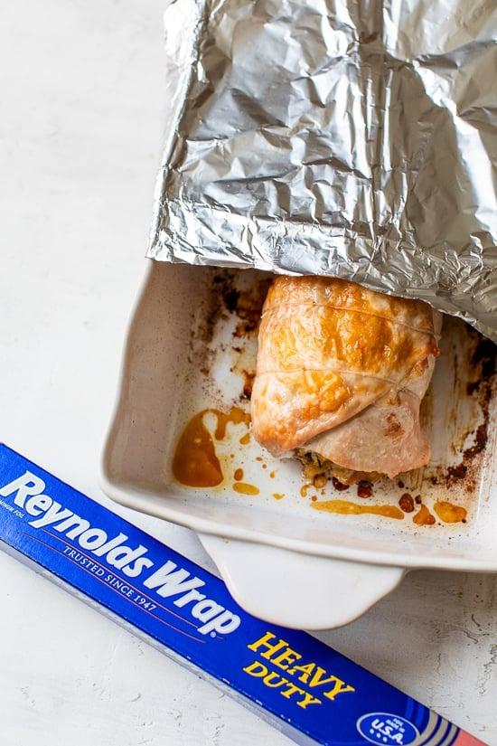 turkey breast in baking dish with foil.