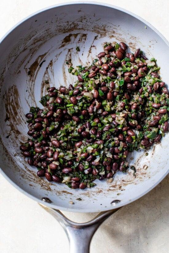 black beans and poblano peppers in a skillet