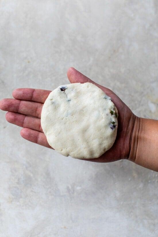 raw pupusa in hand