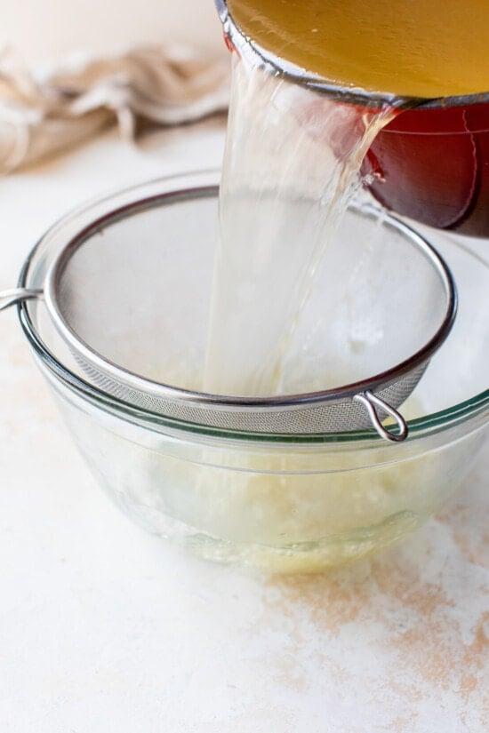 Draining Turkey Stock through a mesh sieve